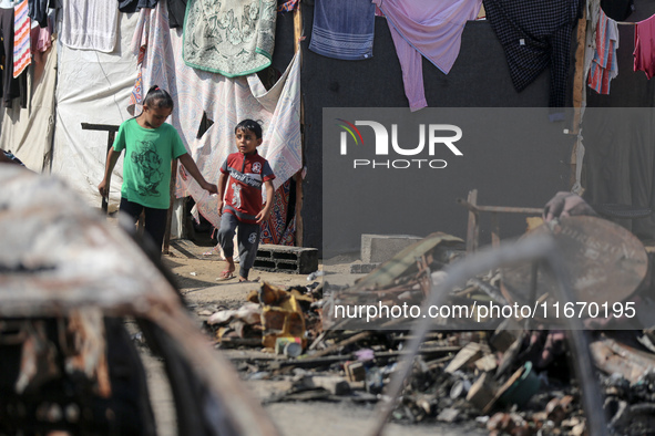 Palestinian displaced people are present at the site of an Israeli airstrike on the tents of the displaced inside the Al-Aqsa Martyrs Hospit...