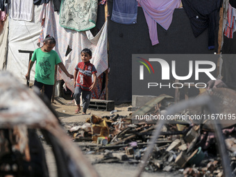 Palestinian displaced people are present at the site of an Israeli airstrike on the tents of the displaced inside the Al-Aqsa Martyrs Hospit...