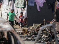 Palestinian displaced people are present at the site of an Israeli airstrike on the tents of the displaced inside the Al-Aqsa Martyrs Hospit...