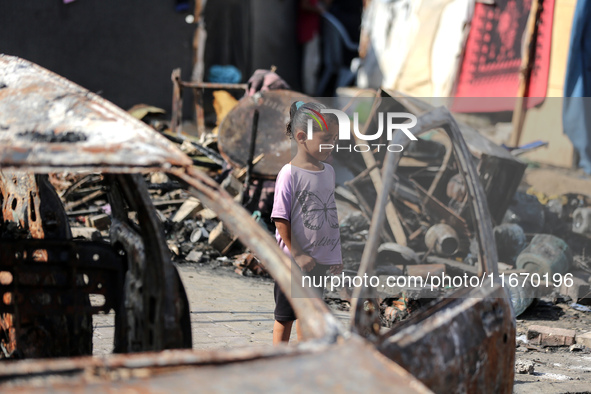 Palestinian displaced people are present at the site of an Israeli airstrike on the tents of the displaced inside the Al-Aqsa Martyrs Hospit...