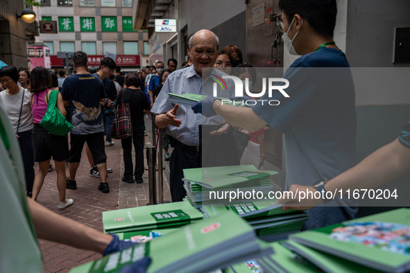 A man receives a copy of the 2024 Policy Address in Hong Kong, China, on October 16, 2024. Today, the Hong Kong Chief Executive John Lee ann...