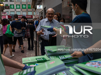 A man receives a copy of the 2024 Policy Address in Hong Kong, China, on October 16, 2024. Today, the Hong Kong Chief Executive John Lee ann...