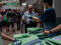 A man receives a copy of the 2024 Policy Address in Hong Kong, China, on October 16, 2024. Today, the Hong Kong Chief Executive John Lee ann...