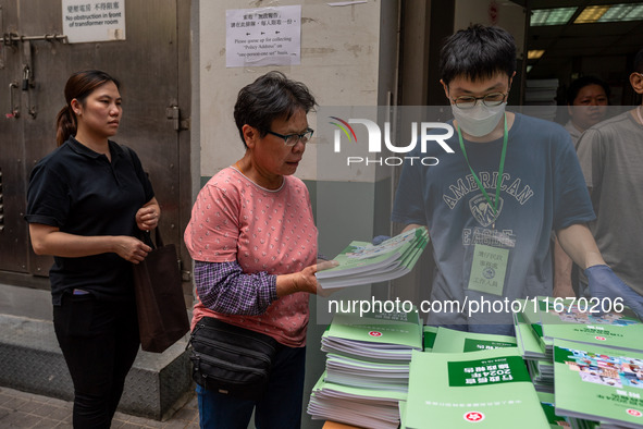 A woman receives a copy of the 2024 Policy Address in Hong Kong, China, on October 16, 2024. The Hong Kong Chief Executive John Lee announce...