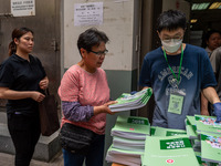 A woman receives a copy of the 2024 Policy Address in Hong Kong, China, on October 16, 2024. The Hong Kong Chief Executive John Lee announce...