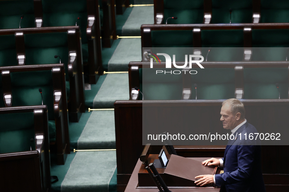 Polish Prime Minister Donald Tusk speaks, as opposition Law and Justice party members left the hall, during the Polish Parliament session in...