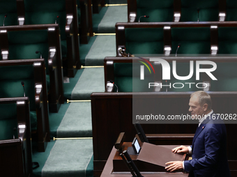 Polish Prime Minister Donald Tusk speaks, as opposition Law and Justice party members left the hall, during the Polish Parliament session in...