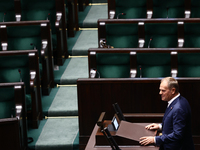 Polish Prime Minister Donald Tusk speaks, as opposition Law and Justice party members left the hall, during the Polish Parliament session in...