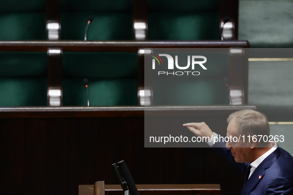 Polish Prime Minister Donald Tusk speaks, as opposition Law and Justice party members left the hall, during the Polish Parliament session in...