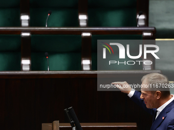 Polish Prime Minister Donald Tusk speaks, as opposition Law and Justice party members left the hall, during the Polish Parliament session in...