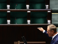 Polish Prime Minister Donald Tusk speaks, as opposition Law and Justice party members left the hall, during the Polish Parliament session in...