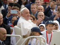 Pope Francis waves to the crowd from the popemobile as he arrives for the weekly general audience at Saint Peter's Square in The Vatican on...