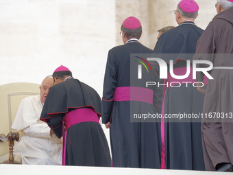 Pope Francis talks with a bishop at the end of his weekly general audience at Saint Peter's Square in The Vatican on October 16, 2024. (