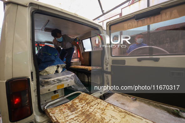 Morgue workers remove the body of a Russian climber who dies while summiting Mt. Dhaulagiri, the 7th highest peak in the world, from a hears...