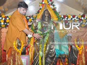 A Hindu priest performs puja on the occasion of Lakshmi Puja in Guwahati, India, on October 16, 2024. Laxmi is one of the most revered and w...