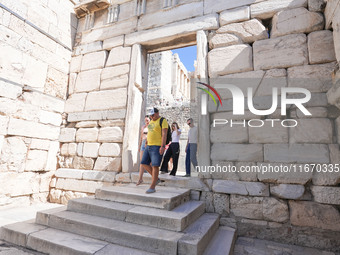 Tourists visit the Acropolis Hill in Athens, Greece, on October 16, 2024. (