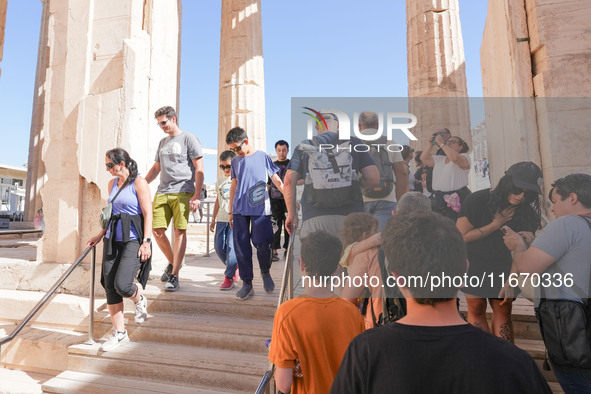 Tourists visit the Acropolis Hill in Athens, Greece, on October 16, 2024. 