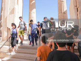 Tourists visit the Acropolis Hill in Athens, Greece, on October 16, 2024. (