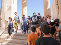 Tourists visit the Acropolis Hill in Athens, Greece, on October 16, 2024. (