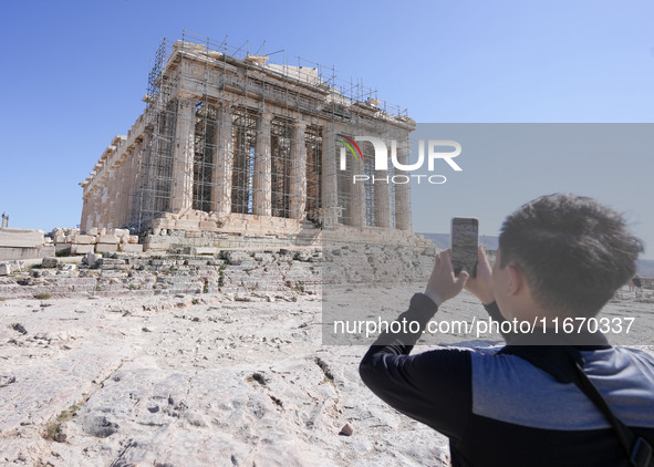 Tourists visit the Acropolis Hill in Athens, Greece, on October 16, 2024. 