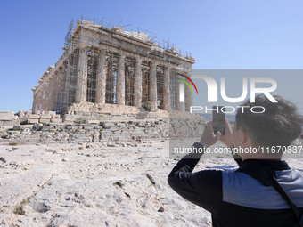 Tourists visit the Acropolis Hill in Athens, Greece, on October 16, 2024. (