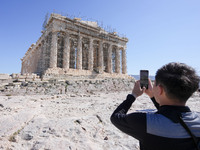 Tourists visit the Acropolis Hill in Athens, Greece, on October 16, 2024. (