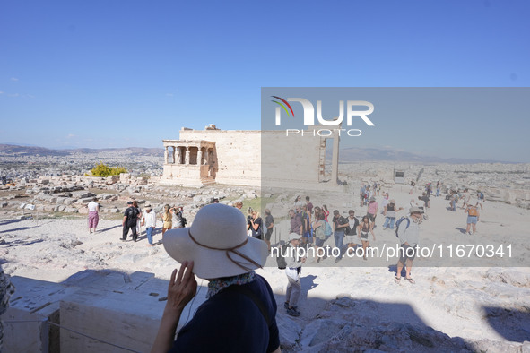 Tourists visit the Acropolis Hill in Athens, Greece, on October 16, 2024. 