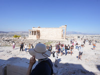 Tourists visit the Acropolis Hill in Athens, Greece, on October 16, 2024. (