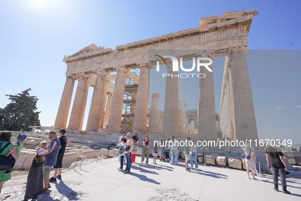 Tourists visit the Acropolis Hill in Athens, Greece, on October 16, 2024. 