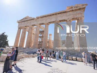 Tourists visit the Acropolis Hill in Athens, Greece, on October 16, 2024. (