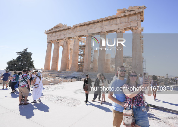 Tourists visit the Acropolis Hill in Athens, Greece, on October 16, 2024. 