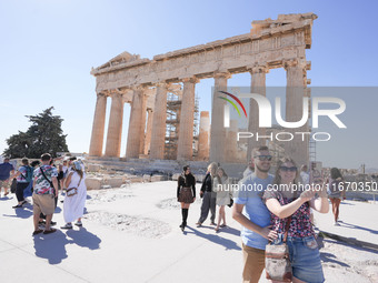 Tourists visit the Acropolis Hill in Athens, Greece, on October 16, 2024. (