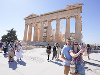 Tourists visit the Acropolis Hill in Athens, Greece, on October 16, 2024. (