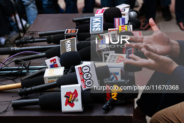 Microphones of various news channels are placed on a table during a press conference of Sajad Lone in Srinagar, Jammu and Kashmir, India, on...