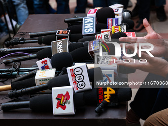 Microphones of various news channels are placed on a table during a press conference of Sajad Lone in Srinagar, Jammu and Kashmir, India, on...