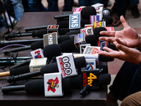 Microphones of various news channels are placed on a table during a press conference of Sajad Lone in Srinagar, Jammu and Kashmir, India, on...