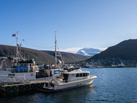 A view of the harbor of Tromso with the Tromsdalstinden mountain in background in Tromso, Norway on September 25, 2024. Tromso is the bigges...