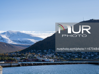 A view of the harbor of Tromso with the Tromsdalstinden mountain in background in Tromso, Norway on September 25, 2024. Tromso is the bigges...