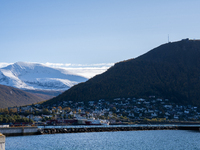 A view of the harbor of Tromso with the Tromsdalstinden mountain in background in Tromso, Norway on September 25, 2024. Tromso is the bigges...