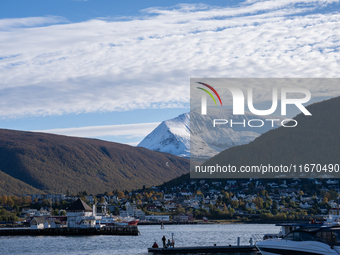 A view of the harbor of Tromso with the Tromsdalstinden mountain in background in Tromso, Norway on September 25, 2024. Tromso is the bigges...