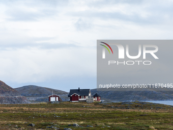 A traditional red Norwegian house sits in the remote landscape of Nordkapp, Norway, on September 27, 2024. Nordkapp, located at the northern...