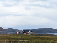 A traditional red Norwegian house sits in the remote landscape of Nordkapp, Norway, on September 27, 2024. Nordkapp, located at the northern...