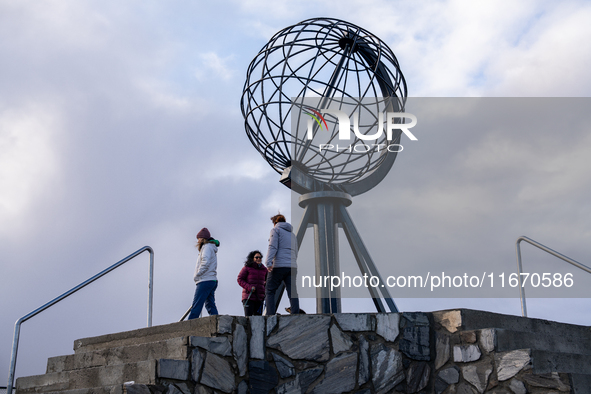 Tourists watches the steel globe in North Cape, Nordkapp, Norway on September 27, 2024. Nordkapp or North Cape is considered the northernmos...