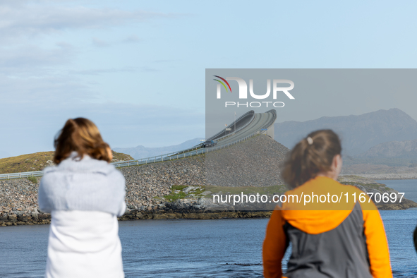 Tourists take pictures on a bridge along the Atlantic Ocean Road in Norway on September 18, 2024. The Atlantic Road was voted the most beaut...