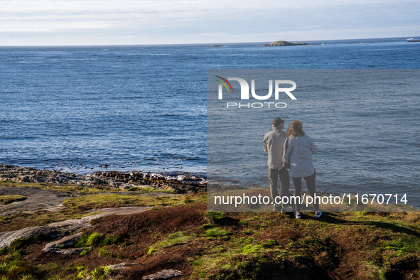 Tourists walk along a scenic pathway near a bridge on the Atlantic Ocean Road in Norway, on September 18, 2024. The Atlantic Road in Norway...