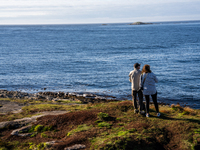 Tourists walk along a scenic pathway near a bridge on the Atlantic Ocean Road in Norway, on September 18, 2024. The Atlantic Road in Norway...