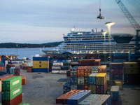 Shipping containers are stacked at the port in Kristiansand, Norway, with the AIDA Cruises ship docked in the background on September 12, 20...