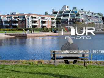 An elderly person sits on a bench overlooking the sea in Kristiansand, Norway on September 13, 2024. Kristiansand is a city and municipality...