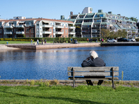 An elderly person sits on a bench overlooking the sea in Kristiansand, Norway on September 13, 2024. Kristiansand is a city and municipality...