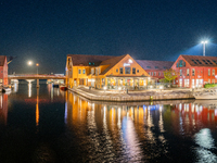 A general view of Fiskebrygga (The Fish Wharf) at night, in Kristiansand, Norway on September 13, 2024. Fiskebrygga  is a former fish landin...